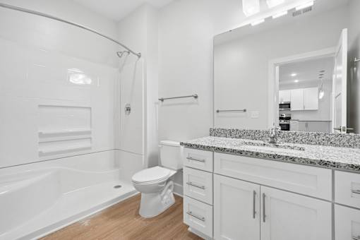 Bathroom with white vanity and speckled granite countertop at The Palms Apartments, South Carolina, 29407