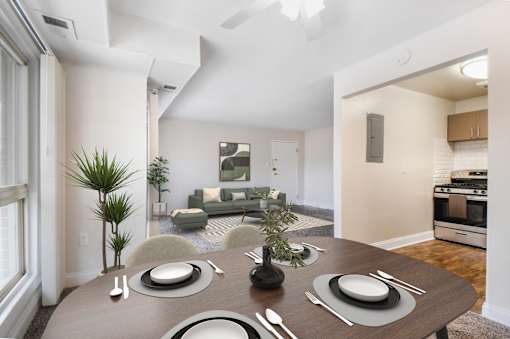 A modern dining room with a table set for two.