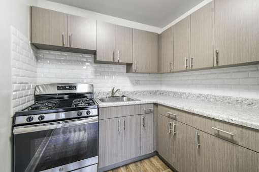 A modern kitchen with a stove and cabinets.