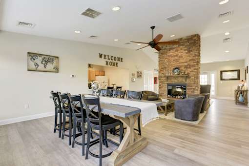 a dining room with a table and chairs in front of a fireplace