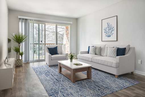 a living room with a couch and chair and a coffee table