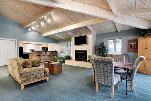 A living room with a sofa, chairs, and a fireplace.