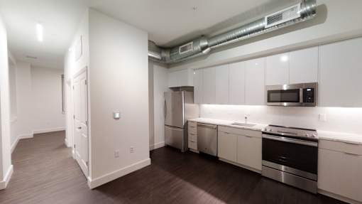 A kitchen with white cabinets and stainless steel appliances.