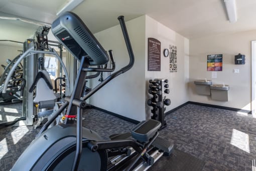 a gym with cardio equipment and weights in a building