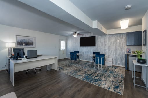 a living room with a table and chairs and a television
