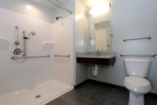 a bathroom with a toilet and a sink and a shower