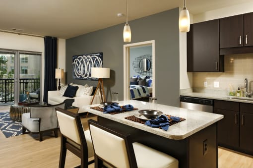 a kitchen and living room with a table and chairs