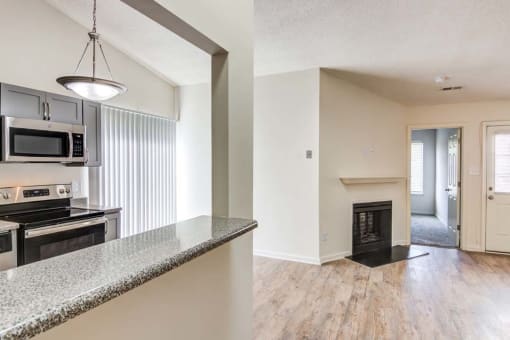 an open kitchen and living room with a fireplace