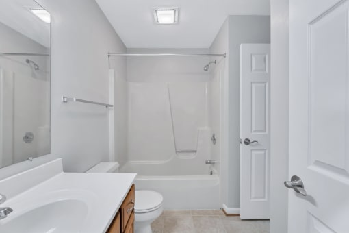 a bathroom with a sink and a toilet and a shower