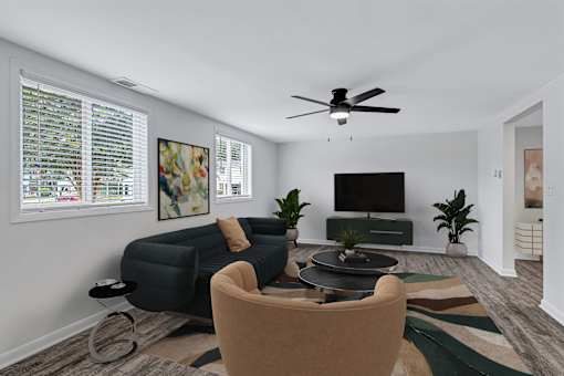 A living room with a sofa, chair, and television.
