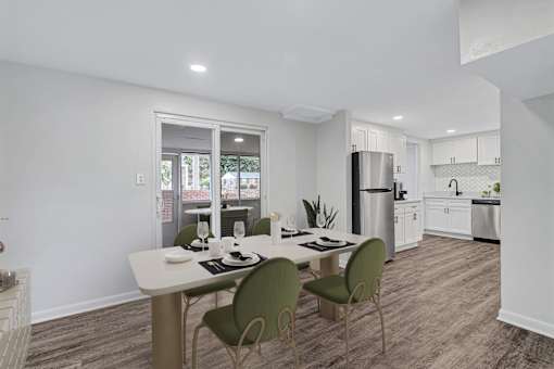 A modern kitchen with a dining table and chairs.