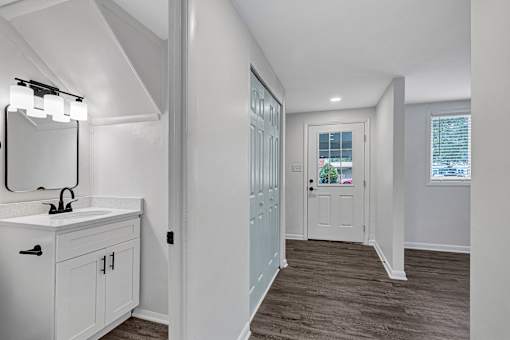 A bathroom with a white sink and a mirror.