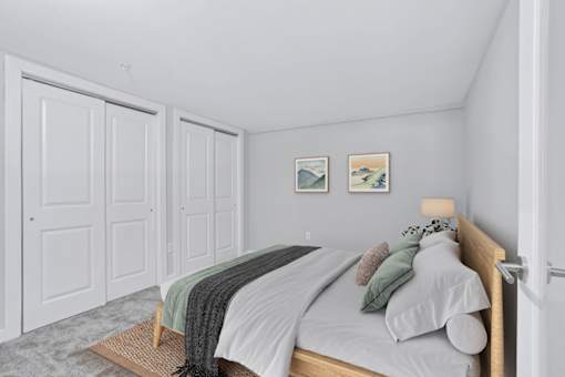 a bedroom with a bed and two closet doors