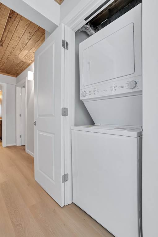 a white washer and dryer in a room next to a door