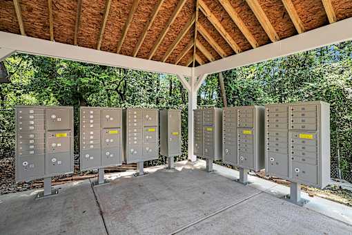 A row of electrical boxes are lined up in a pavilion.