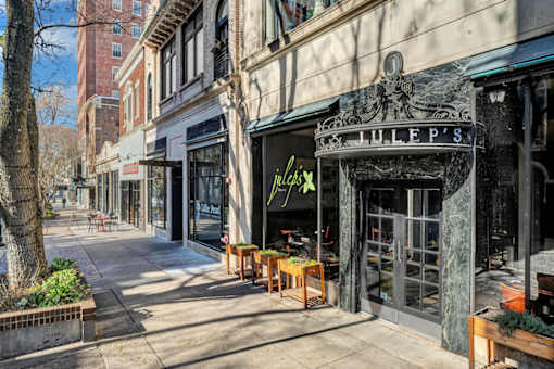 a city street with shops and a sidewalk