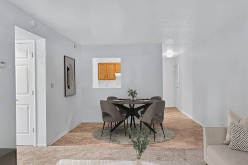 A dining room with a round table and chairs.