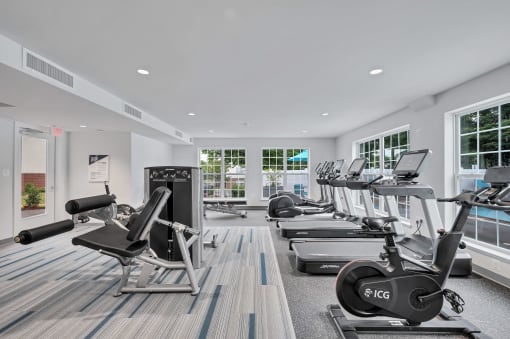 a gym with treadmills and other exercise equipment