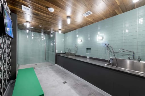 a green mat sits on the floor in front of a sink in a large bathroom with a