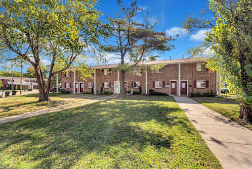 a large brick building with trees in front of it