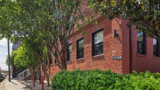 a red brick building with trees in front of it