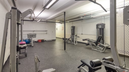 a gym with weights and other equipment in a building