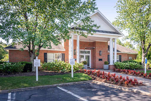 A building with a white roof and a porch with columns.