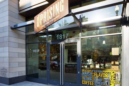 a view of the front of a coffee shop with a sign on the front door