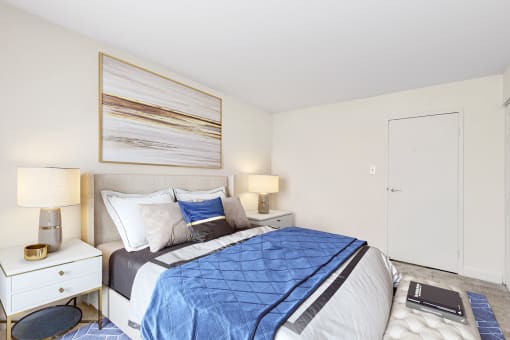 a bedroom with a bed and two night stands and a closet