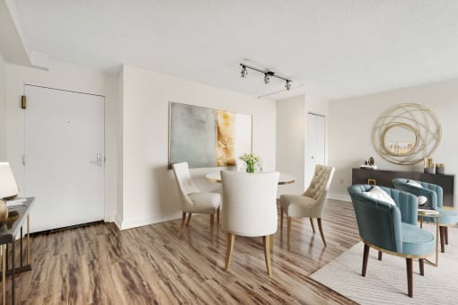a living room and dining room with a table and chairs