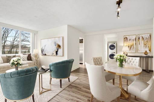 a living room and dining room with white chairs and a table