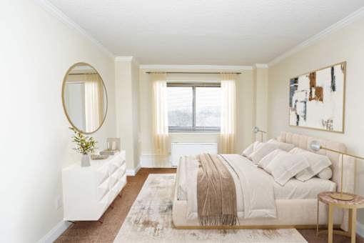 A bedroom with a large bed and a dresser with a mirror.