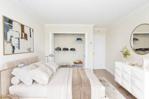 A bedroom with a bed, dresser, and mirror.
