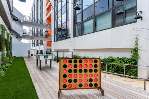 a giant four in arowana game on the patio of an office building