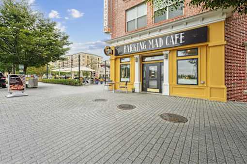A brick building with a yellow front and a sign that says