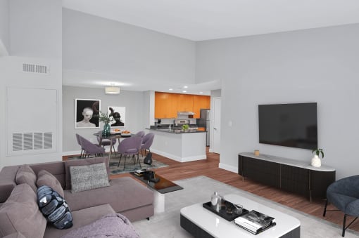 A furnished luxury apartment living room with large dining room and stylish kitchen in the background.
