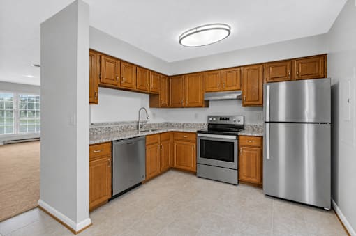 A kitchen with wooden cabinets and stainless steel appliances.