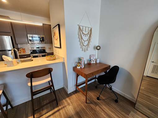 A kitchen with a table and chairs.