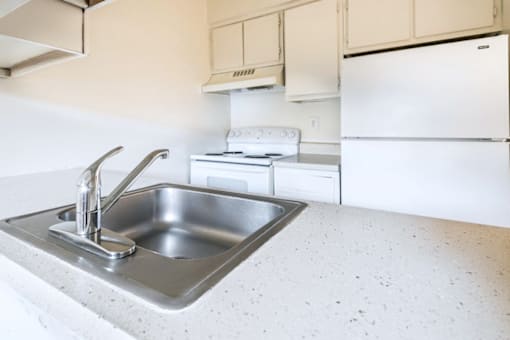 A kitchen with a sink and a stove.