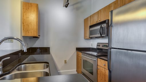 a kitchen with stainless steel appliances and wooden cabinets
