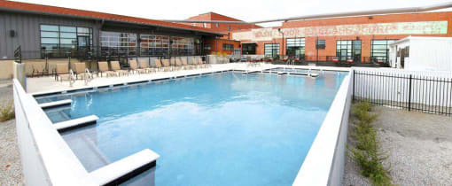 a large swimming pool in front of a building