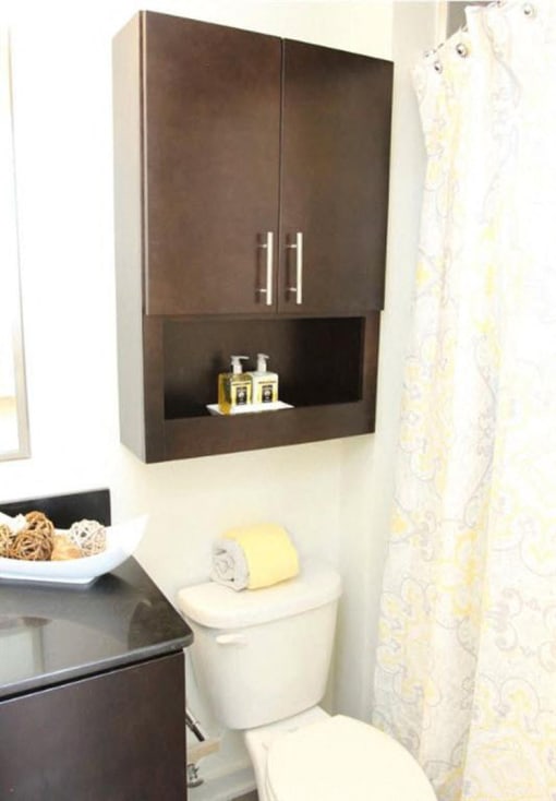 a bathroom with a toilet and a cabinet