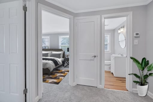 a bedroom with a bed and a bathroom in a 555 waverly unit