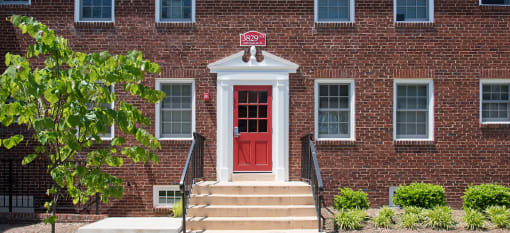 Clarendon Court Apartments a two-story red brick building with a red door and windows