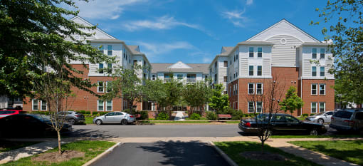 an apartment building with cars parked in front of it