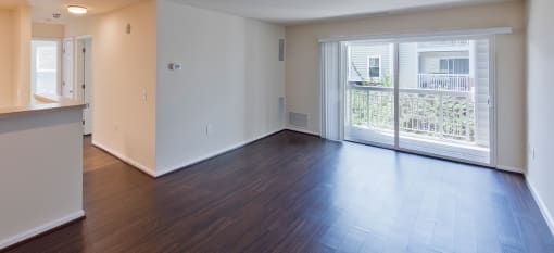 an empty living room with a balcony