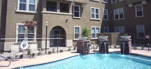 a swimming pool in front of an apartment building
