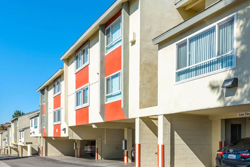 Exterior apartment building with parking garages at Mission Plaza Apartments, Los Angeles, CA