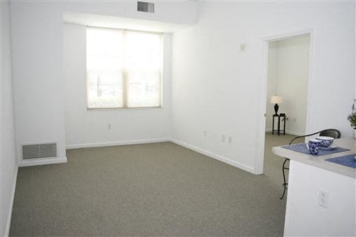 Apartment bedroom with carpet floors unfurnished-McCormack House at Forest Park Southeast Community Room