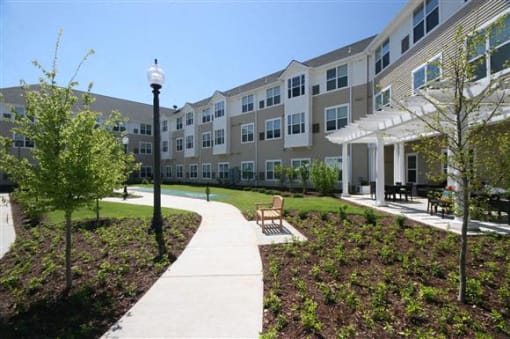 Sidewalk view of apartment buildings-Senior Living at Cambridge Heights Apartments, St. Louis, MO